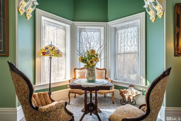 a dining room with furniture and wooden floor