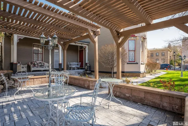 a view of living room with patio furniture and a garden