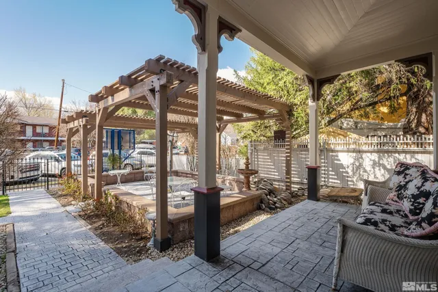 a building outdoor space with patio furniture and potted plants