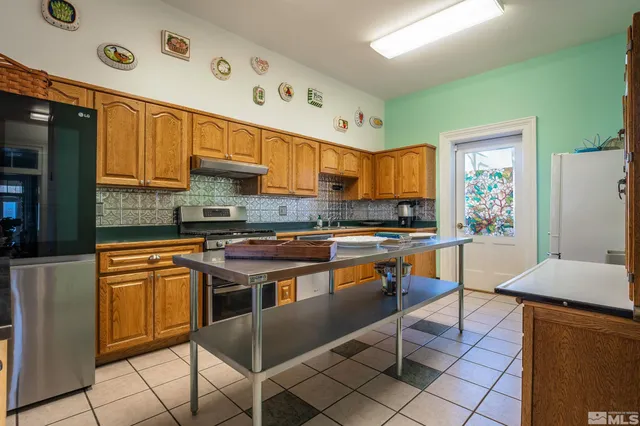 a kitchen with stainless steel appliances granite countertop a stove and a refrigerator