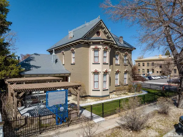 a front view of a house with outdoor seating