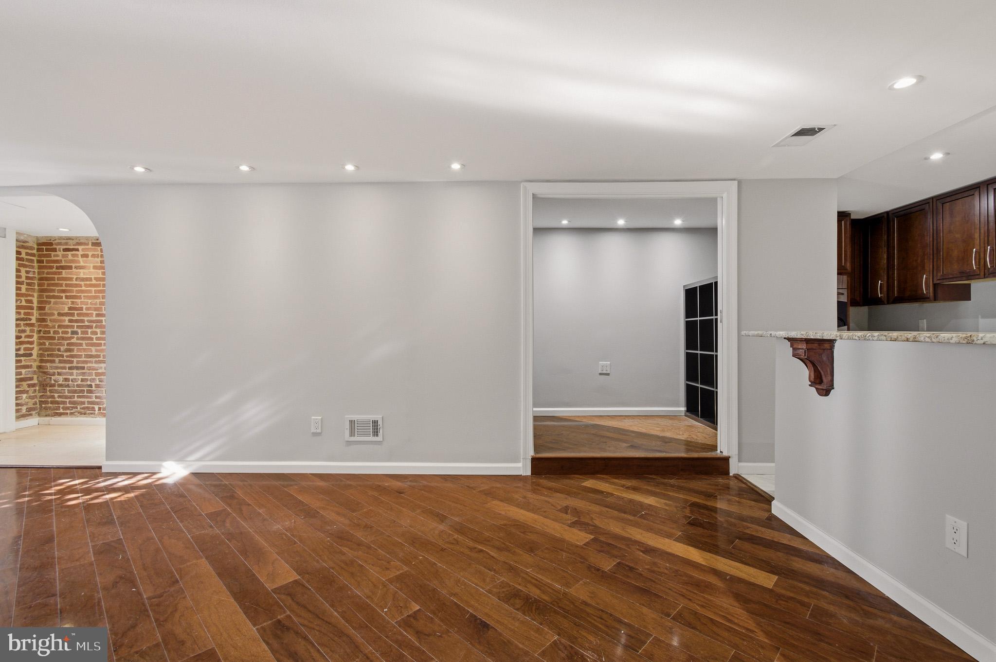 2117 S Street Northwest Washington, DC 20008 - Photo 26 of 63 an empty room with wooden floor and windows