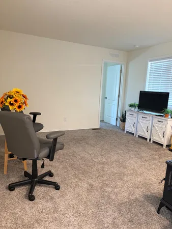 a bedroom with a bed and a chair