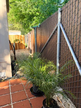a backyard of a house with wooden floor barbeque oven and yard