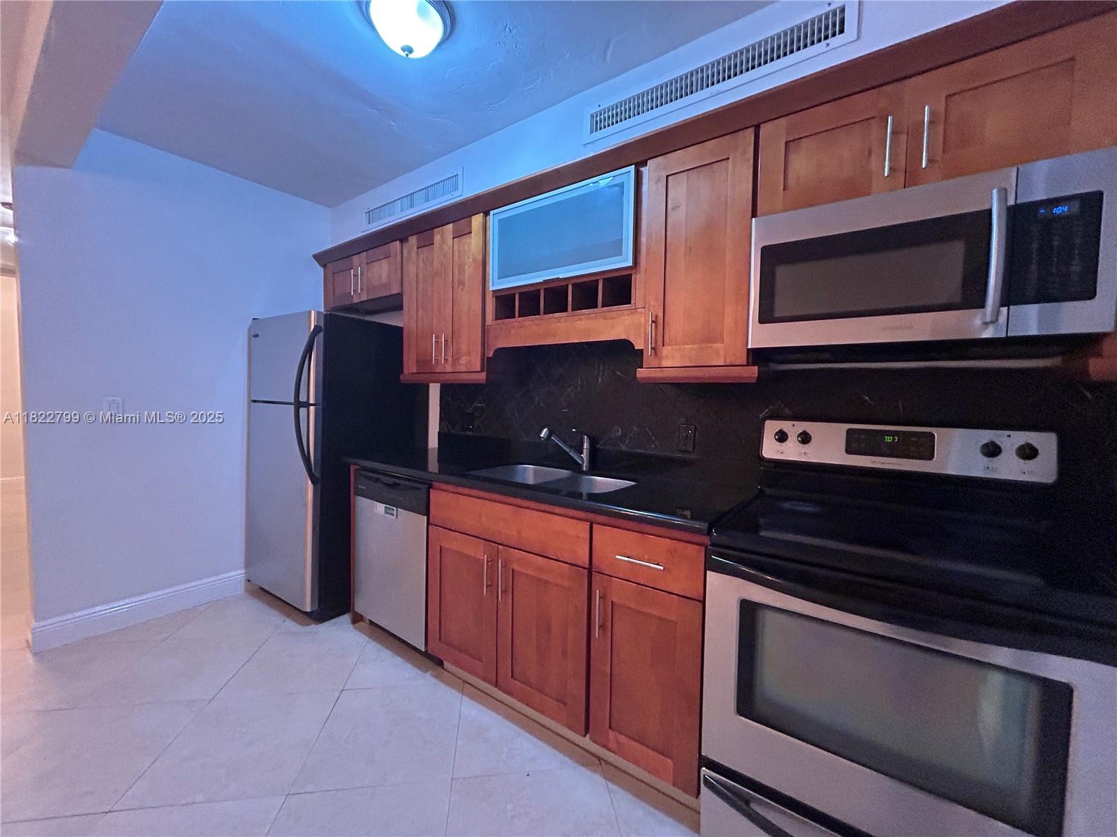 a kitchen with stainless steel appliances a stove microwave and cabinets
