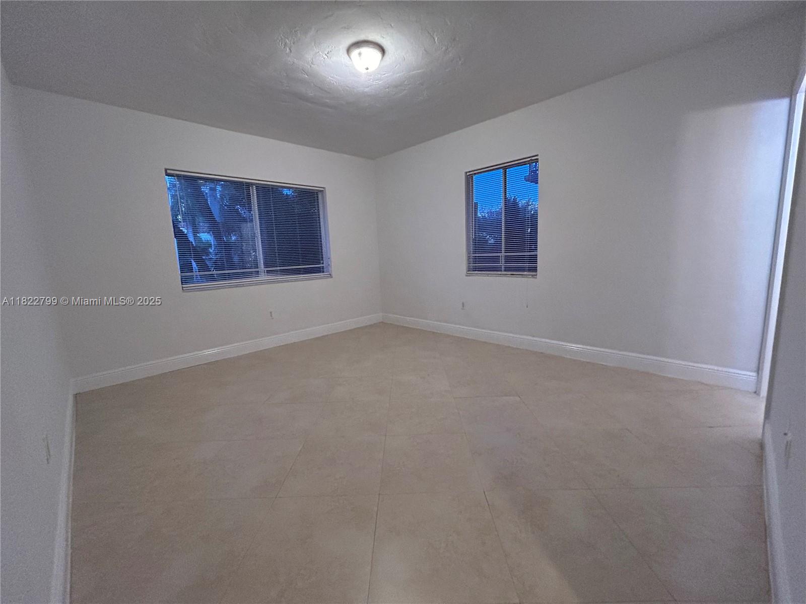 2880 Pine Tree Drive, Unit 1 Miami Beach, FL 33140 - Photo 7 of 13 an empty room with windows