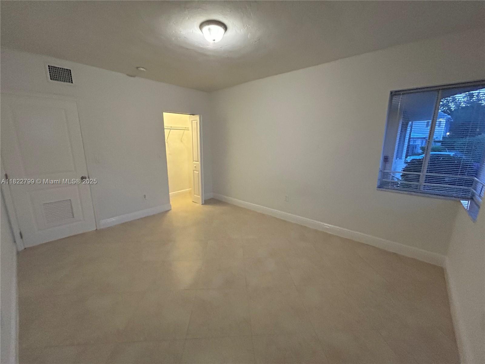 2880 Pine Tree Drive, Unit 1 Miami Beach, FL 33140 - Photo 8 of 13 an empty room with a window