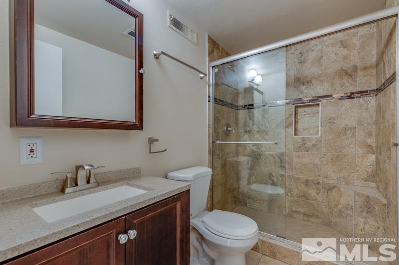 1755 Carlin Street Reno, NV 89503 - Photo 11 of 26 a bathroom with a granite countertop sink toilet and shower