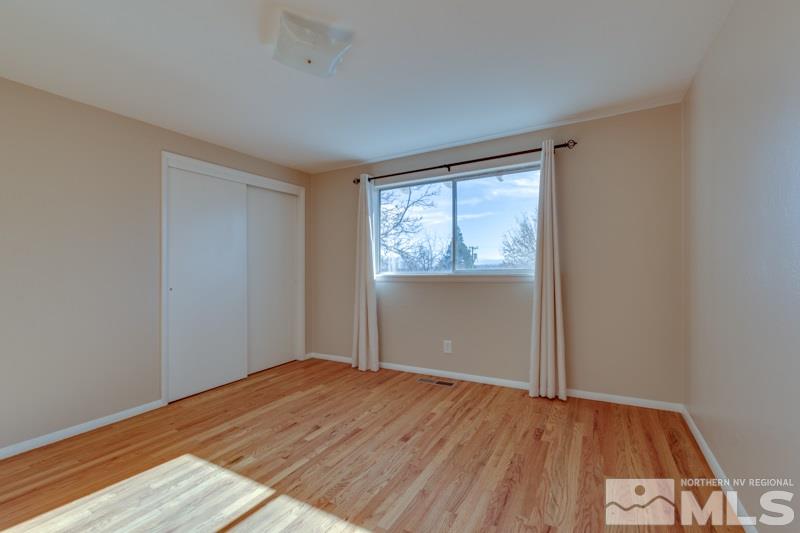 1755 Carlin Street Reno, NV 89503 - Photo 14 of 26 a view of empty room with wooden floor and fan