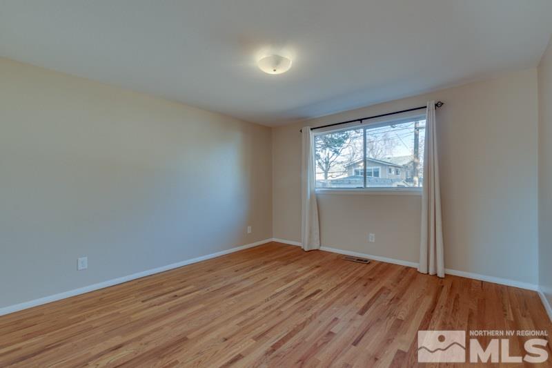 1755 Carlin Street Reno, NV 89503 - Photo 16 of 26 an empty room with wooden floor and windows