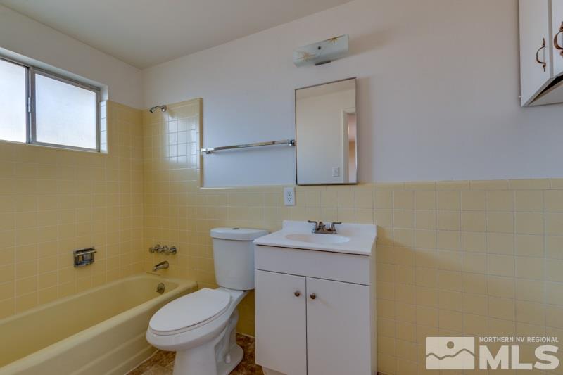 1755 Carlin Street Reno, NV 89503 - Photo 17 of 26 a bathroom with a sink toilet vanity and bathtub