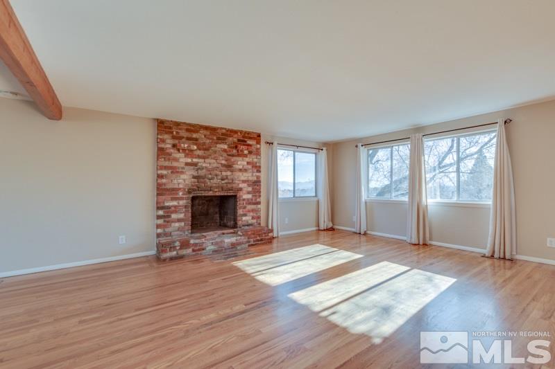 1755 Carlin Street Reno, NV 89503 - Photo 2 of 26 wooden floor fireplace and windows in an empty room