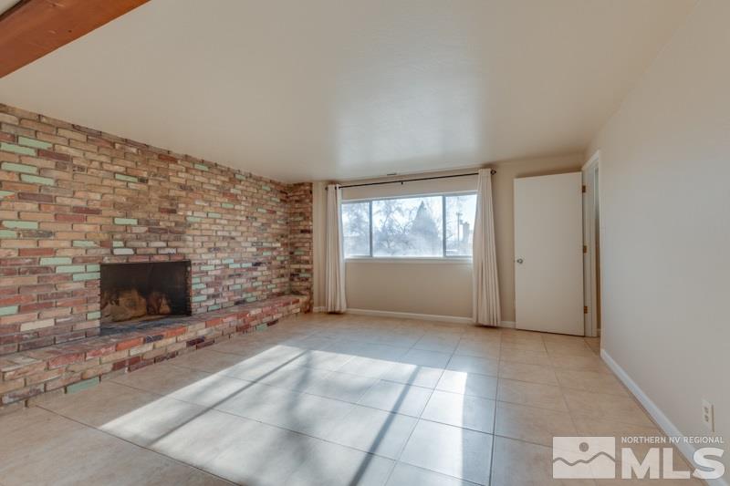 1755 Carlin Street Reno, NV 89503 - Photo 21 of 26 a view of an empty room with a fireplace and a window