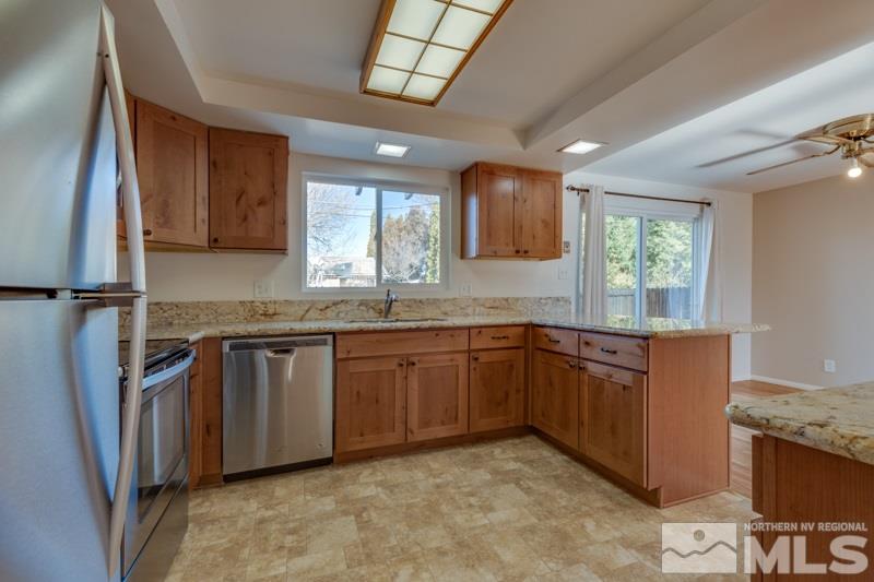 1755 Carlin Street Reno, NV 89503 - Photo 3 of 26 a kitchen with stainless steel appliances granite countertop a sink stove and cabinets