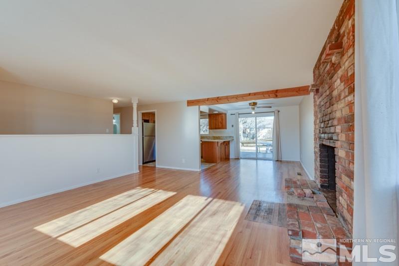 1755 Carlin Street Reno, NV 89503 - Photo 9 of 26 a view of empty room with wooden floor and fireplace