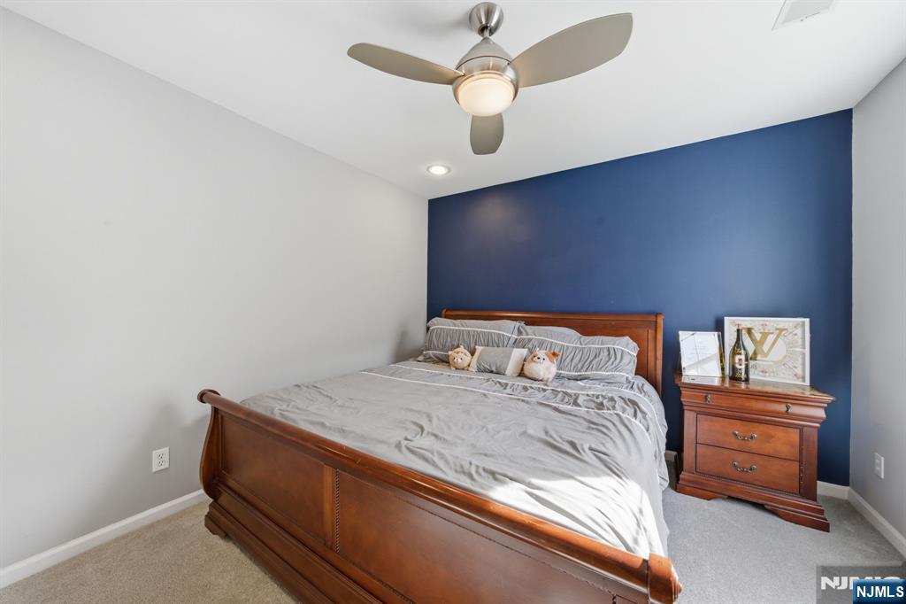 22 Falling Waters Oakland, NJ 07436 - Photo 18 of 43 a bedroom with a bed and a chandelier
