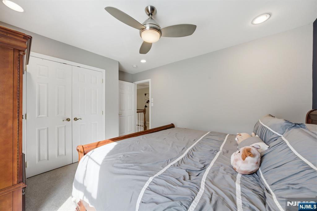 22 Falling Waters Oakland, NJ 07436 - Photo 19 of 43 a bedroom with a bed and a chandelier
