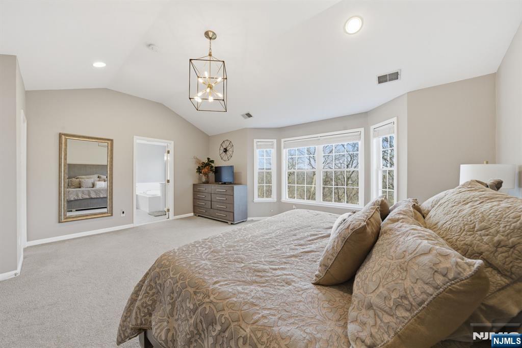 22 Falling Waters Oakland, NJ 07436 - Photo 22 of 43 a spacious bedroom with a large bed and a window