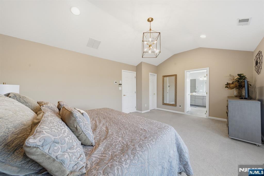 22 Falling Waters Oakland, NJ 07436 - Photo 24 of 43 a spacious bedroom with a bed and cabinets