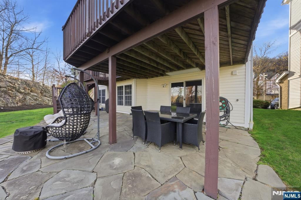 22 Falling Waters Oakland, NJ 07436 - Photo 39 of 43 a view of a porch with chairs and a yard