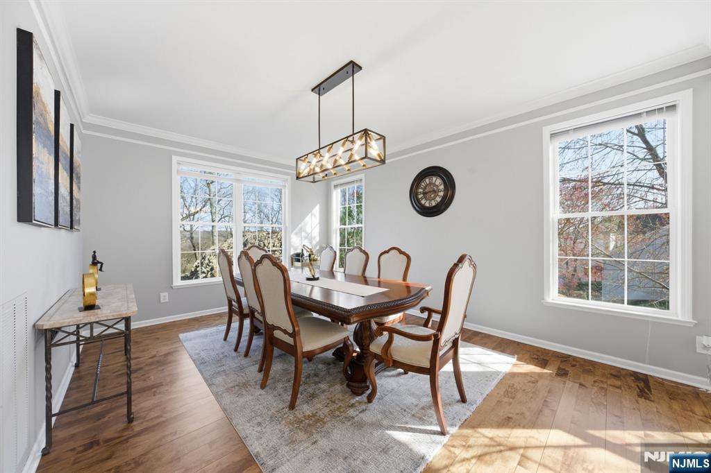 22 Falling Waters Oakland, NJ 07436 - Photo 7 of 43 a dining room with a wooden table and chairs