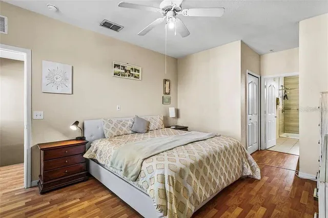 a bedroom with a bed and wooden floor
