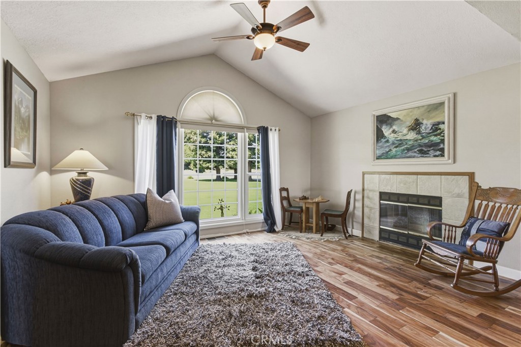 3856 North Gardner Avenue Merced, CA 95340 - Photo 6 of 59 a living room with furniture a fireplace and a chandelier