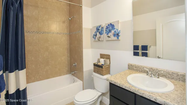 a bathroom with a granite countertop sink toilet and a bathtub