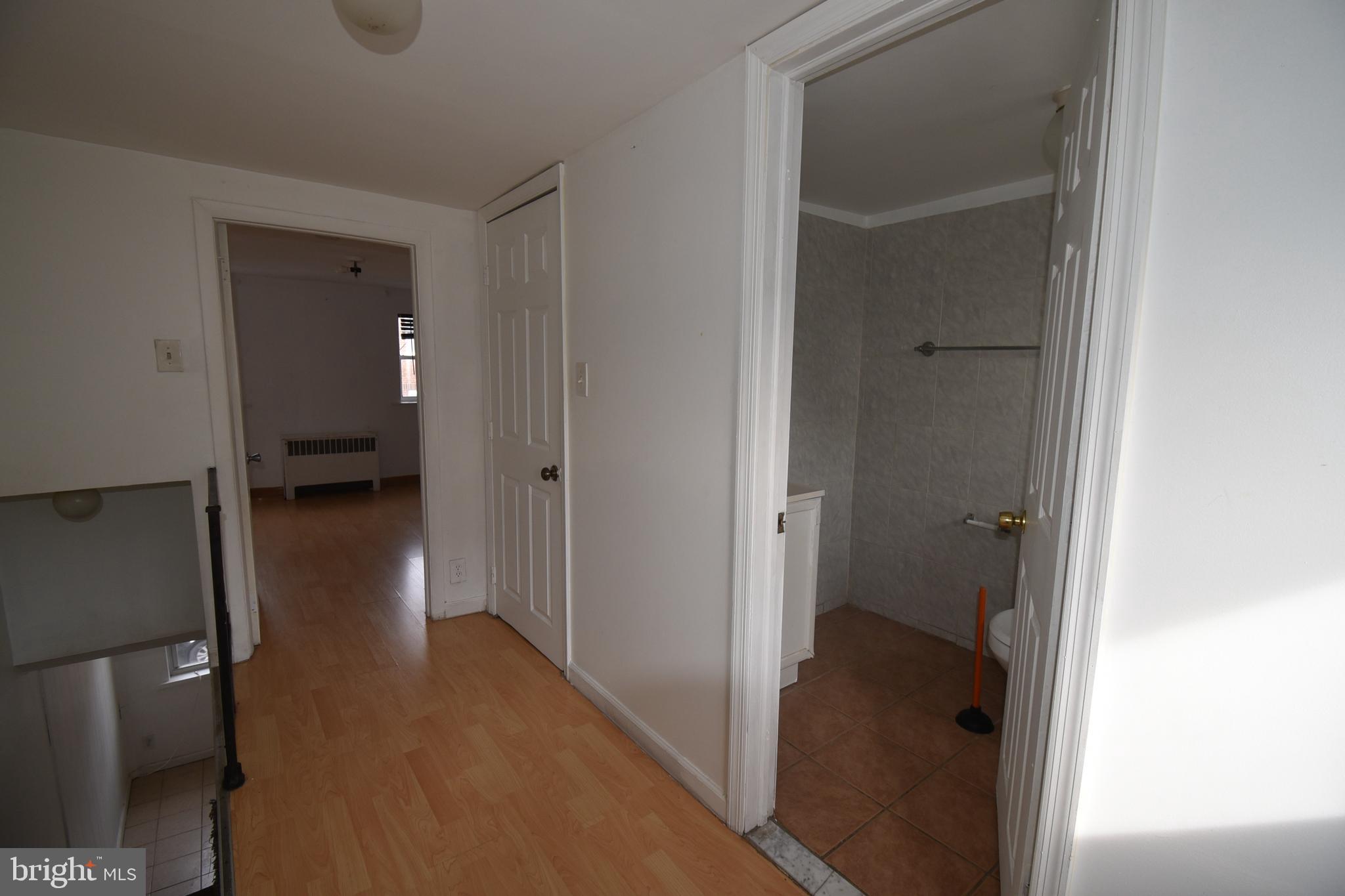 1303 South 8th Street Philadelphia, PA 19147 - Photo 13 of 22 a view of a hallway with wooden floor and a bathroom