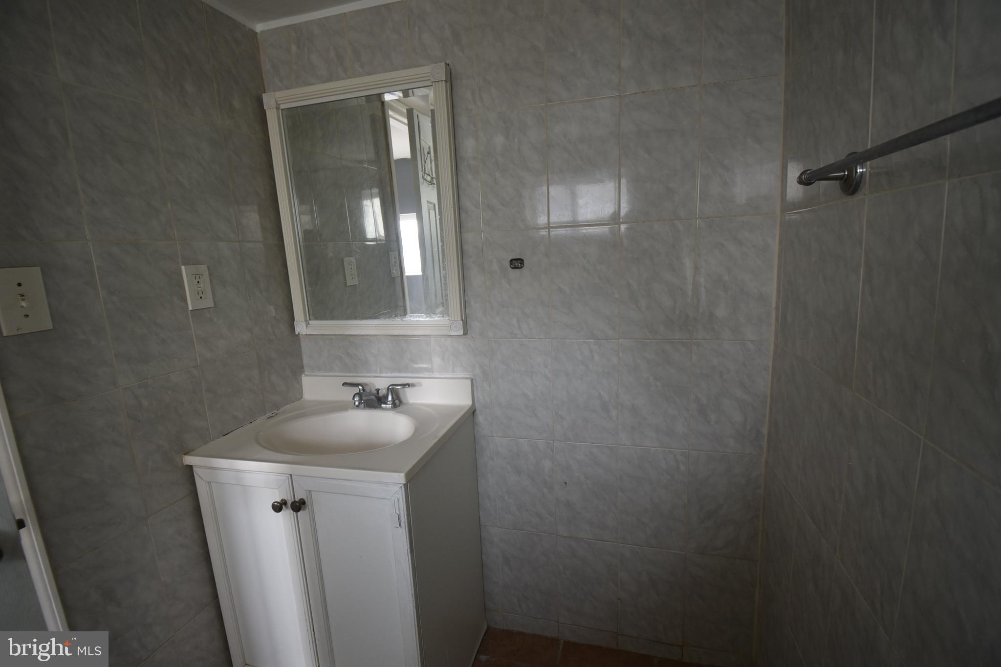 1303 South 8th Street Philadelphia, PA 19147 - Photo 16 of 22 a bathroom with a sink and mirror with toilet