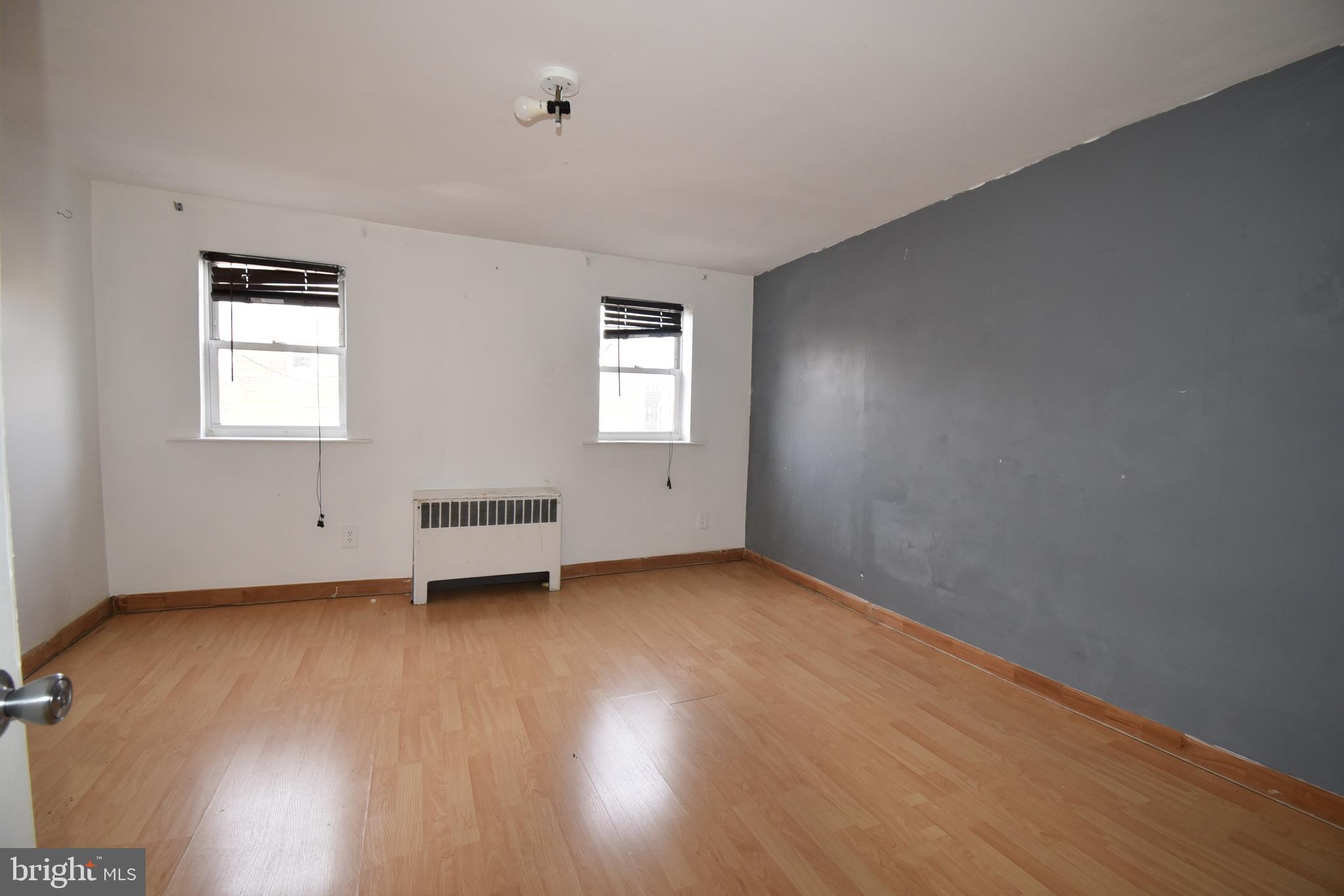 1303 South 8th Street Philadelphia, PA 19147 - Photo 17 of 22 an empty room with wooden floor and windows