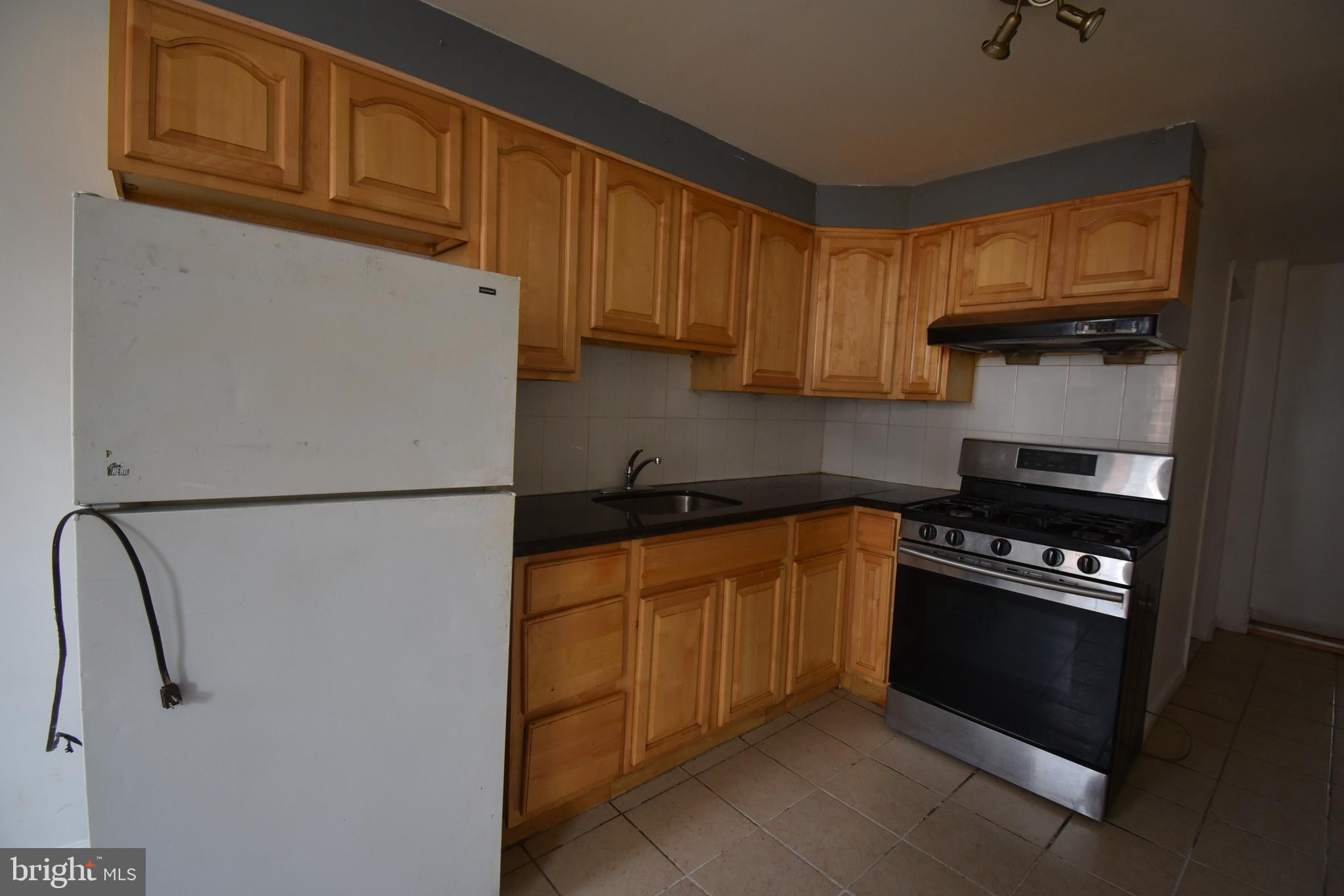 1303 South 8th Street Philadelphia, PA 19147 - Photo 19 of 22 a kitchen with stainless steel appliances granite countertop a refrigerator a stove a sink and dishwasher