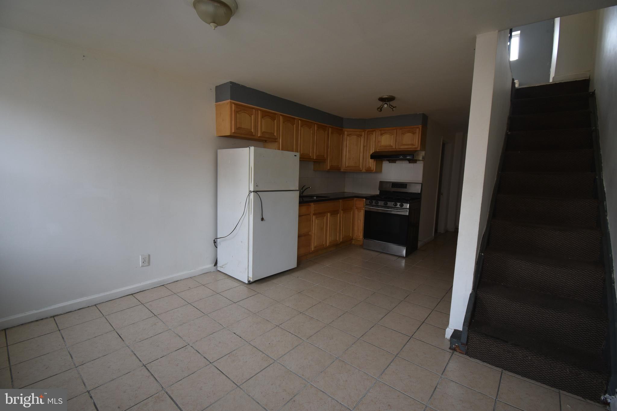 1303 South 8th Street Philadelphia, PA 19147 - Photo 6 of 22 a kitchen with refrigerator and cabinets