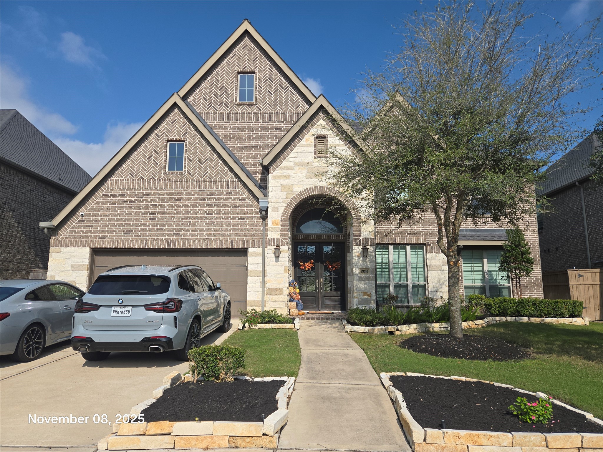 28610 Thornsby Ridge Court Fulshear, TX 77441 - Photo 2 of 7 a front view of a house with a garden