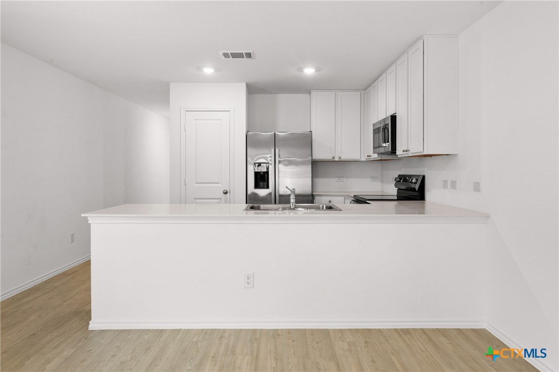 517 Texas Angel Way Jarrell, TX 76537 - Photo 13 of 35 a view of kitchen with stainless steel appliances granite countertop refrigerator sink and stove