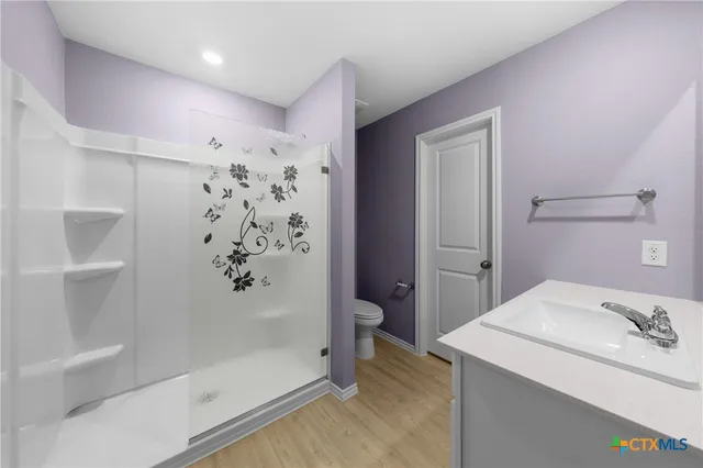 a bathroom with a shower and a sink