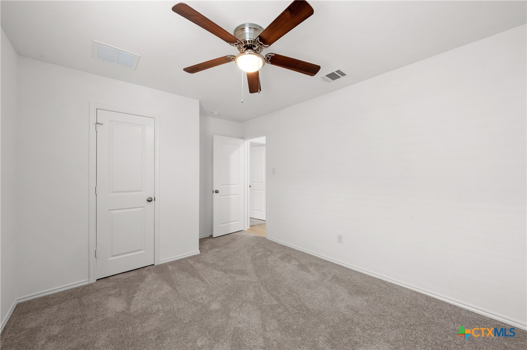 517 Texas Angel Way Jarrell, TX 76537 - Photo 23 of 35 an empty room with a ceiling fan and a window