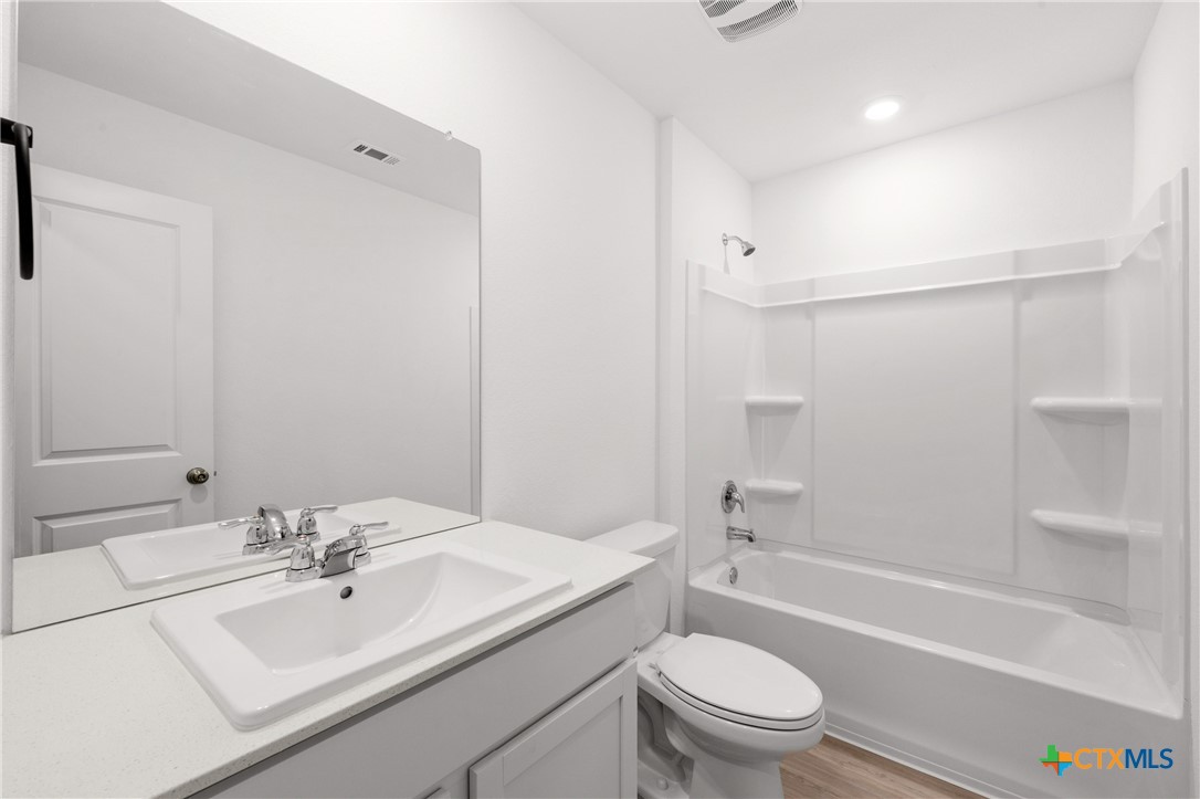 517 Texas Angel Way Jarrell, TX 76537 - Photo 24 of 35 a bathroom with a sink a toilet and shower