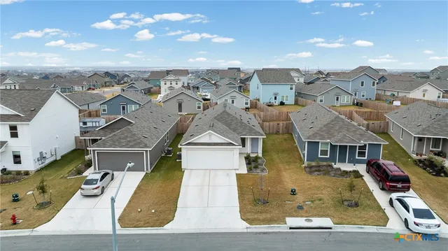 an aerial view of residential houses with outdoor space