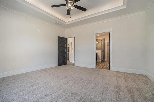 a view of an empty room with a ceiling fan