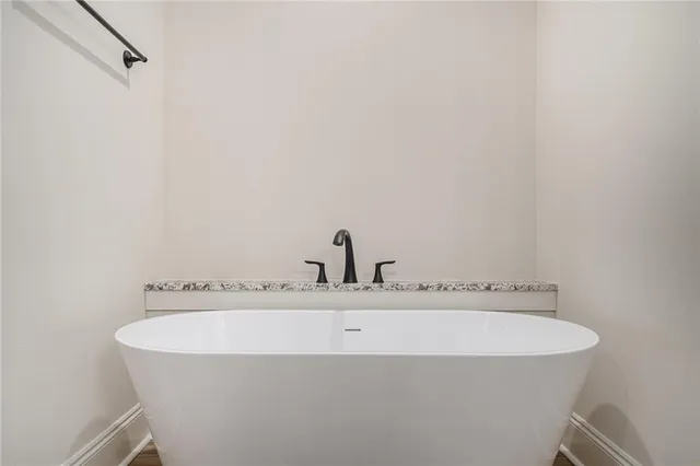 a bathroom with a bathtub and a sink