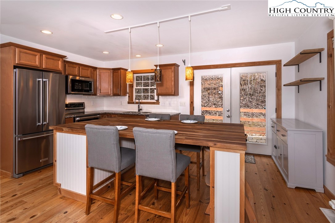 198 Eagles Path Boone, NC 28607 - Photo 12 of 44 a kitchen with stainless steel appliances granite countertop a stove a refrigerator and a refrigerator