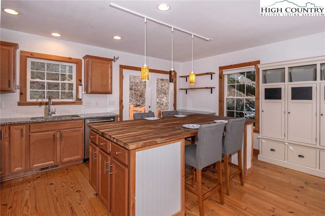198 Eagles Path Boone, NC 28607 - Photo 13 of 44 a kitchen with stainless steel appliances granite countertop a stove a sink dishwasher and a refrigerator with wooden cabinets