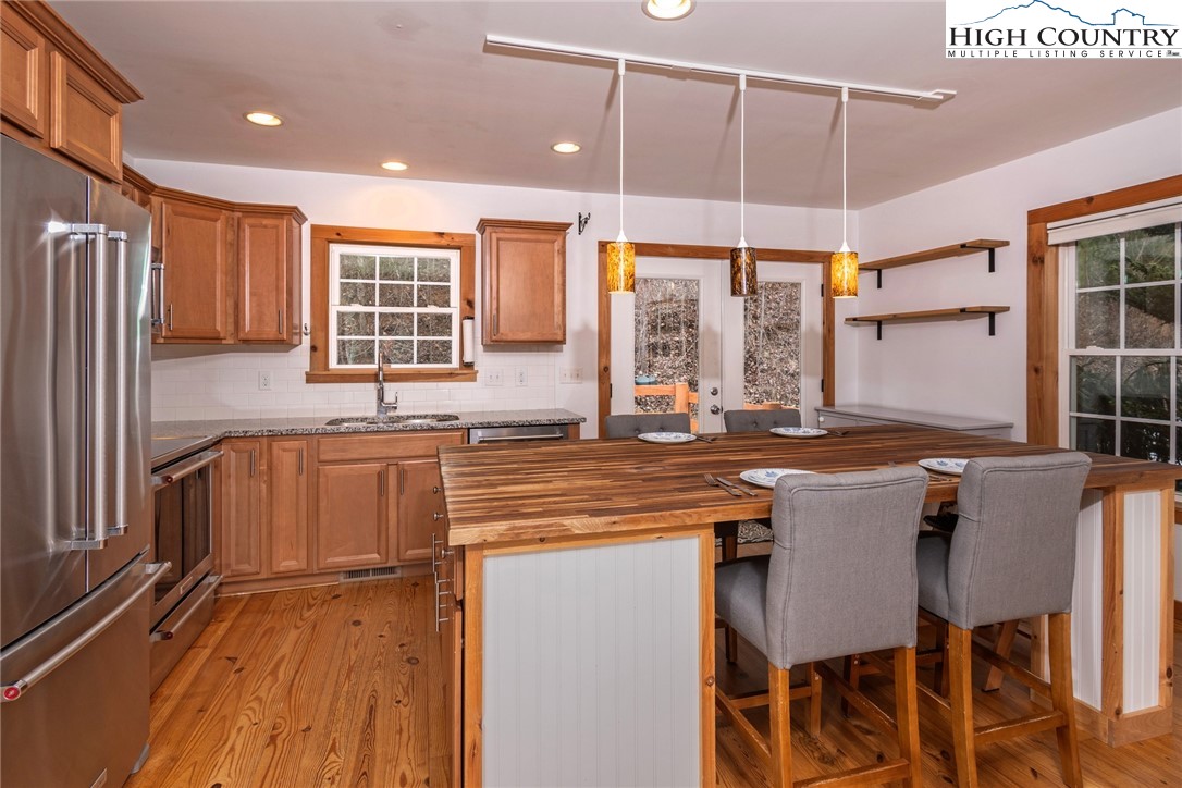 198 Eagles Path Boone, NC 28607 - Photo 15 of 44 a kitchen with stainless steel appliances granite countertop a stove a sink and a refrigerator