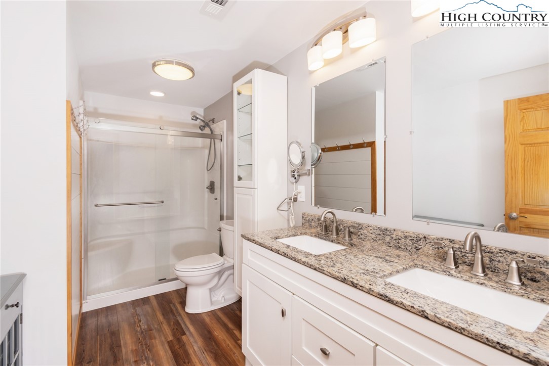198 Eagles Path Boone, NC 28607 - Photo 38 of 44 a bathroom with a granite countertop sink toilet and shower