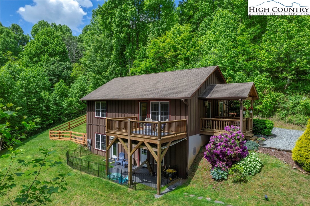198 Eagles Path Boone, NC 28607 - Photo 4 of 44 an aerial view of a house roof deck with table and chairs and potted plants