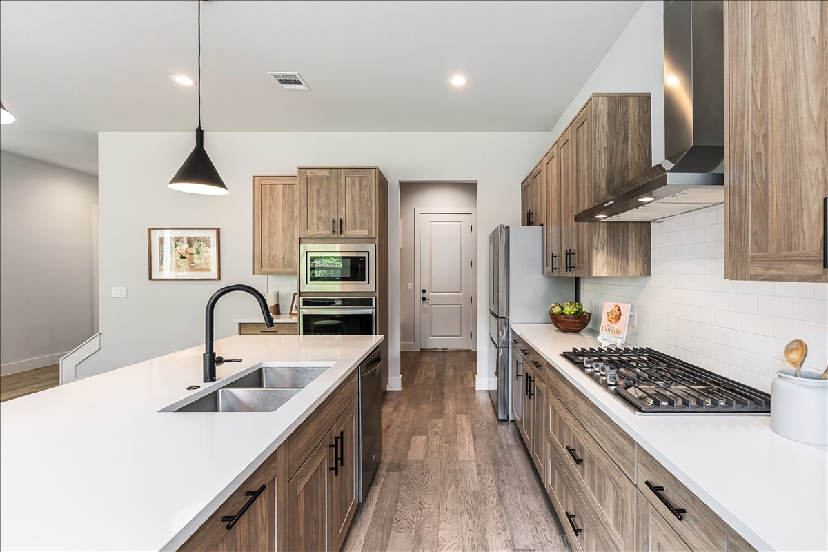 7910 Ryans Way Austin, TX 78726 - Photo 11 of 39 Stainless steel appliances and a gas cooktop create a space designed for everyday cooking and hosting.