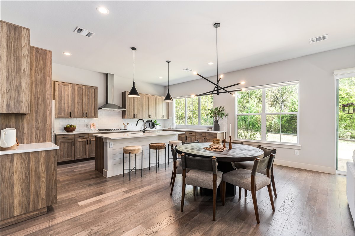 7910 Ryans Way Austin, TX 78726 - Photo 13 of 39 The dining area is perfectly positioned beside large windows that bring in beautiful natural light.