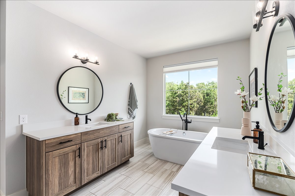 7910 Ryans Way Austin, TX 78726 - Photo 22 of 39 Dual vanities with modern cabinetry provide plenty of storage and countertop space.