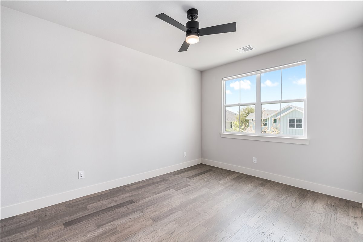 7910 Ryans Way Austin, TX 78726 - Photo 25 of 39 This guest bedroom offers a bright and comfortable space with large windows that bring in abundant natural light.